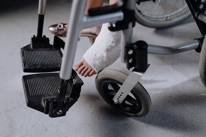 Closeup of a foot in a cast of a person in a wheelchair