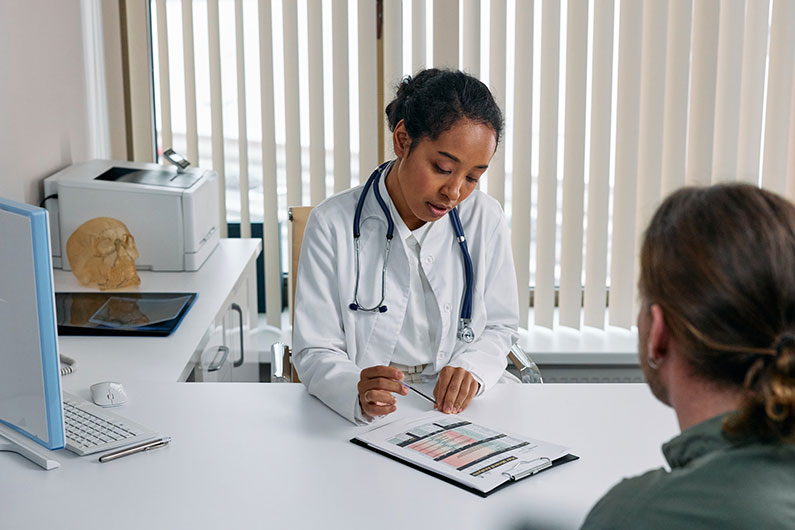 A doctor and patient discuss applying for long term disability A doctor supporting a patient during counseling