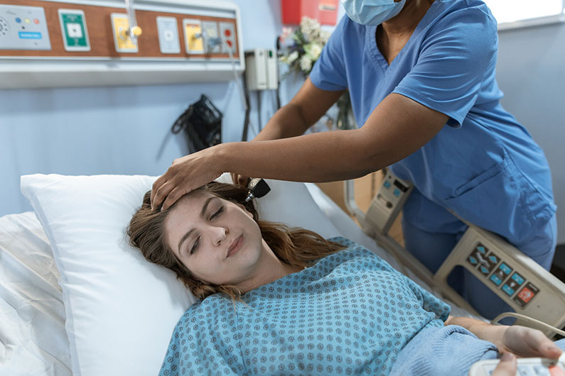 A doctor examines a patient on a bed