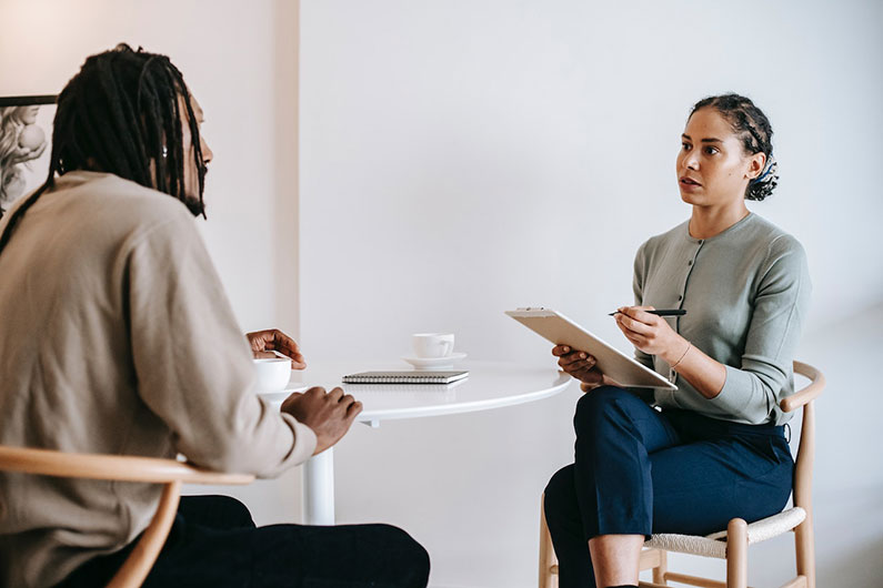 An employer and employee discuss a performance improvement plan.