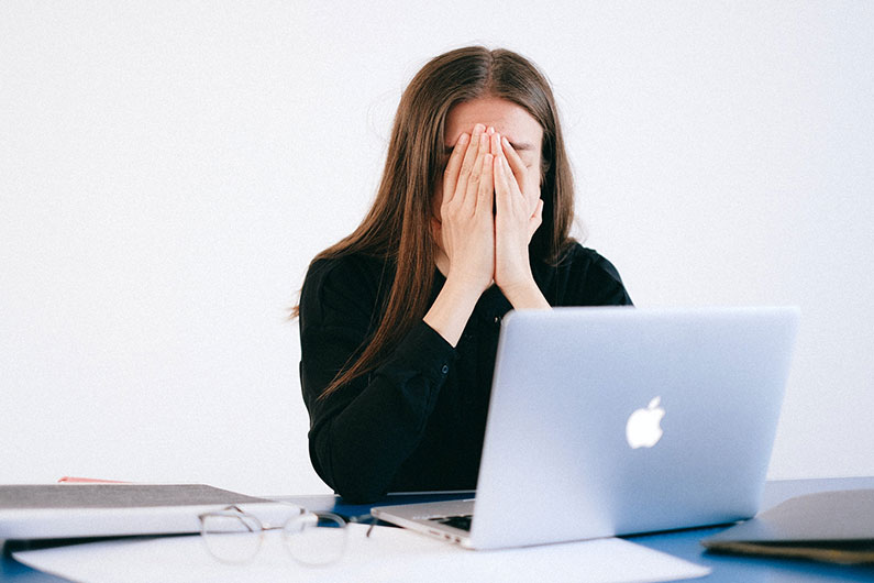 A fired employee covers her face